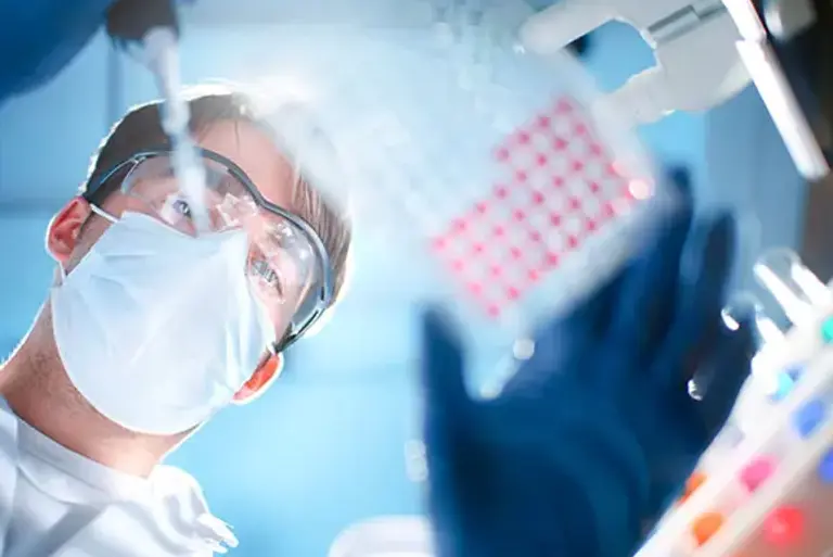 View looking up at a scientist using a pipette