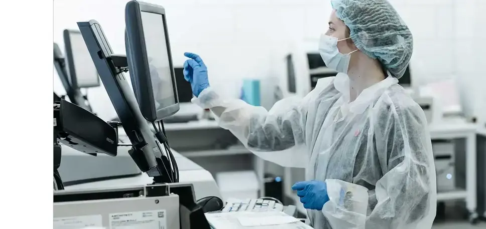 Scientist inputting on a touch screen in a laboratory